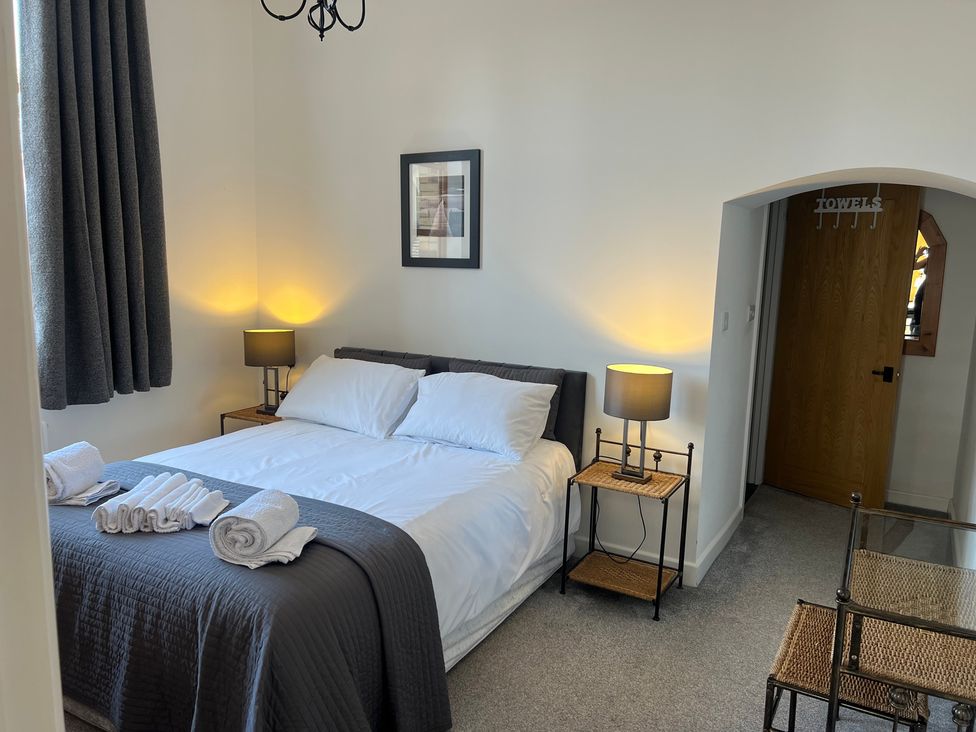 A bedroom with a bed and nightstand at 4 Bickington Road Barnstaple