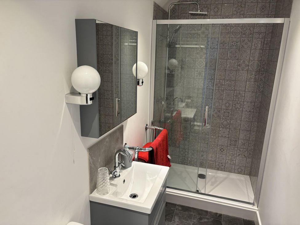 A bathroom with a shower and sink at 4 Bickington Road Barnstaple