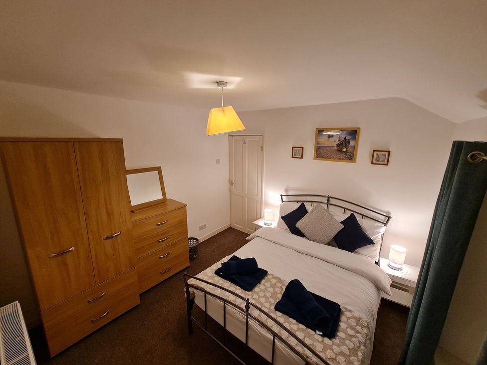 A bedroom with a bed and wardrobe at Blue Haven in Penmaenmawr