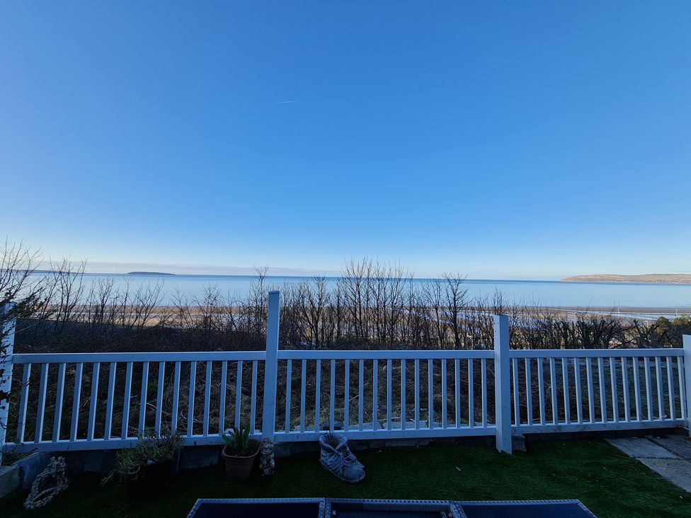 A view of the sea and a beach from the outdoor area at Blue Haven in Penmaenmawr