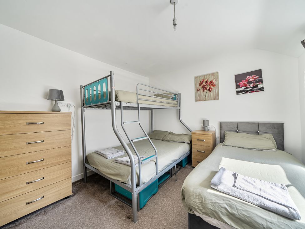 A bedroom with bunk bed and single bed at Blue Haven in Penmaenmawr
