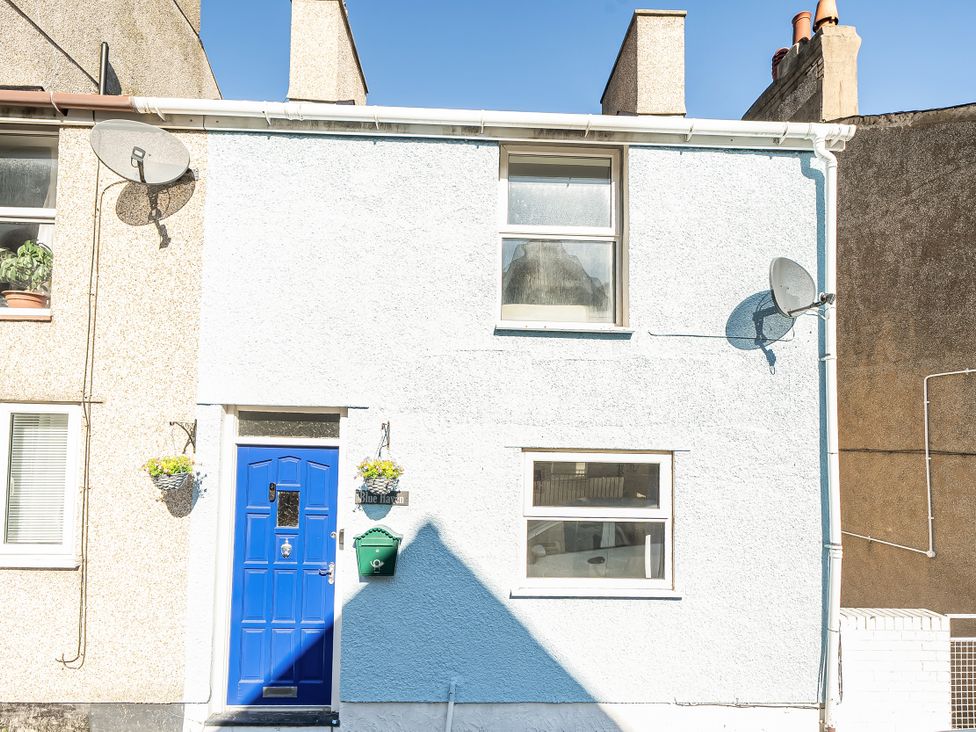 A house with a blue door and windows at Blue Haven in Penmaenmawr