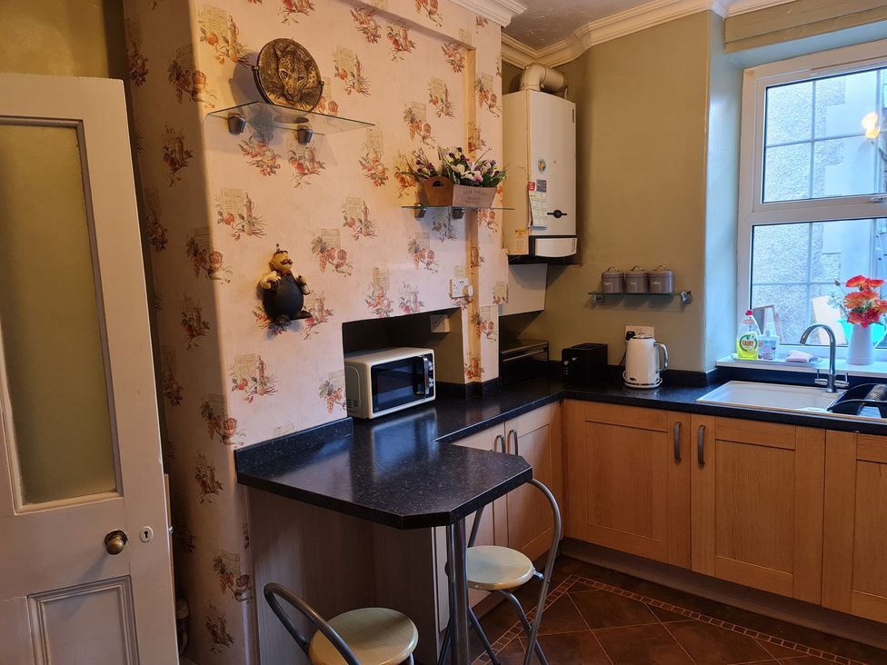A kitchen with a microwave and a sink at Sea View Escape in Penmaenmawr