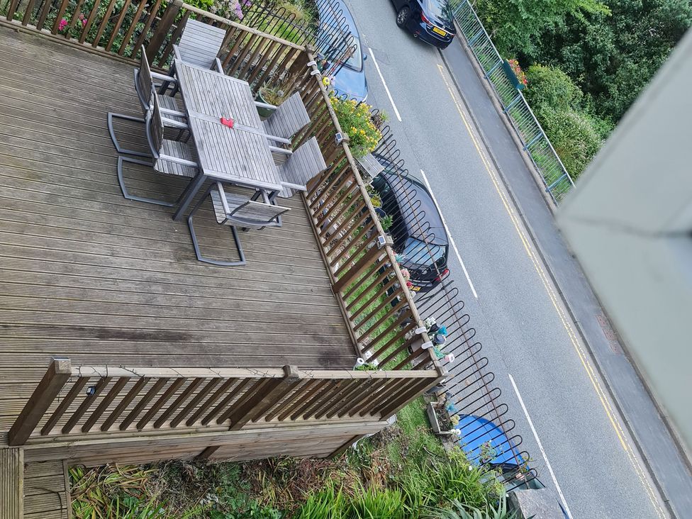 A deck with a table and chairs at Sea View Escape in Penmaenmawr