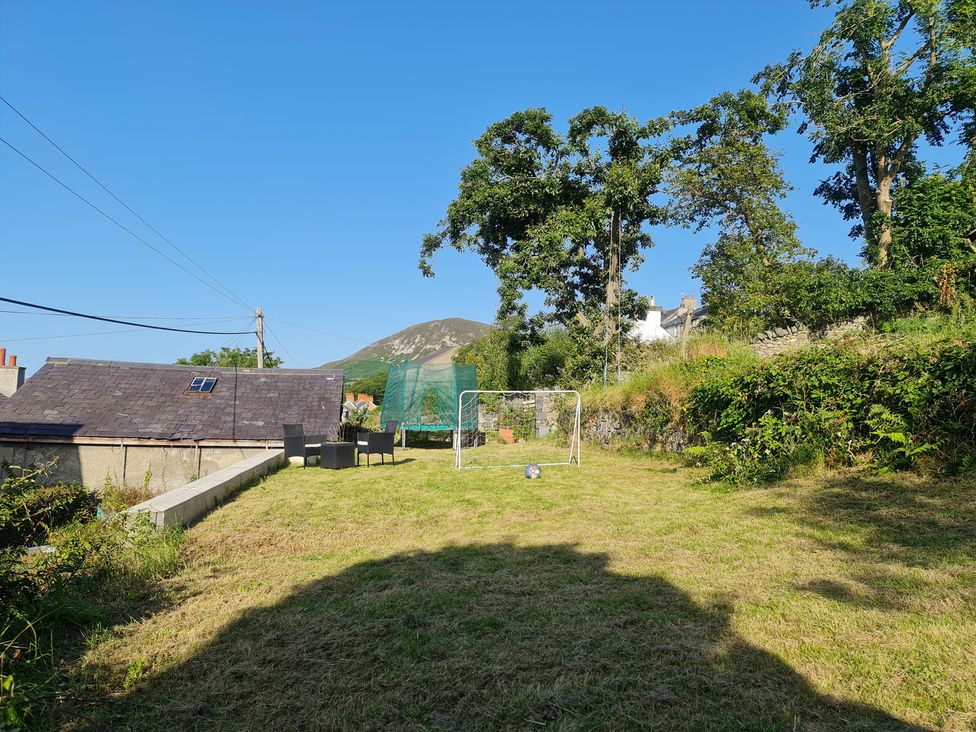 A garden with a goalpost and seating area at Sea View Escape in Penmaenmawr