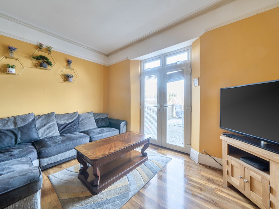 A living room with a sofa and television at Sea View Escape in Penmaenmawr