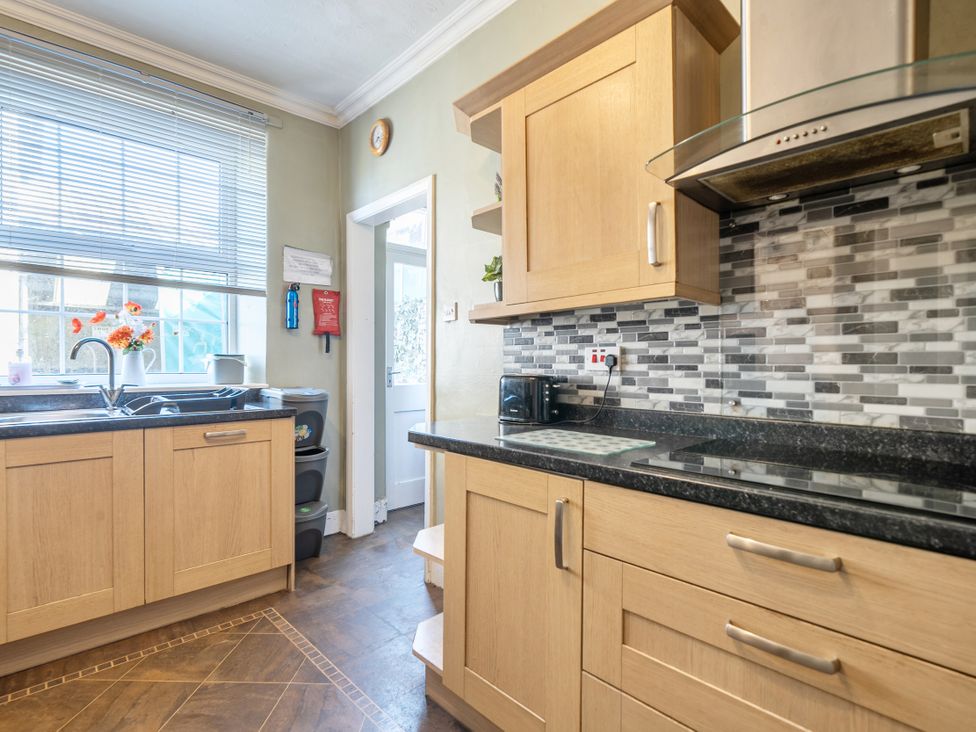 A kitchen with cabinets and sink at Sea View Escape in Penmaenmawr