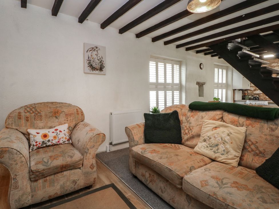 A living room with a sofa and armchair at Meadow View Cottage in Matlock