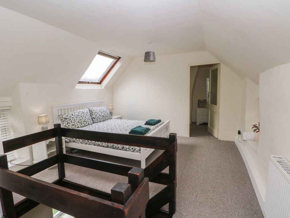 A bedroom with a double bed and bedside table at Meadow View Cottage in Matlock