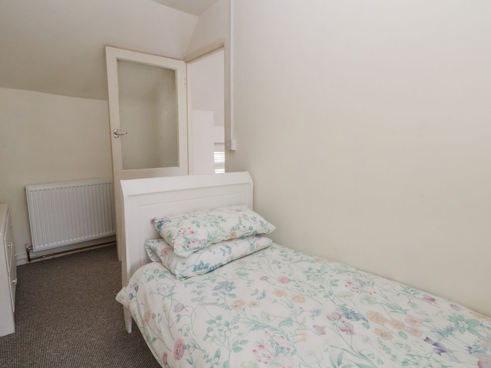 A bedroom with a bed and pillows at Meadow View Cottage in Matlock