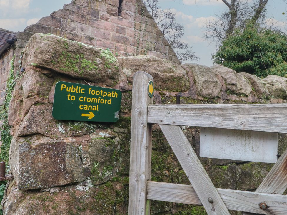 A sign directing to a public footpath to Cromford Canal at Meadow View Cottage in Matlock