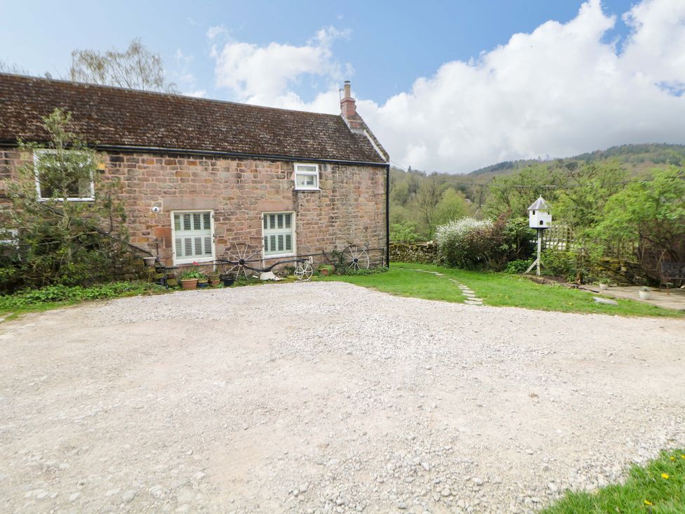 An exterior view of a stone house with a garden area at Meadow View Cottage Whatstandwell near Crich