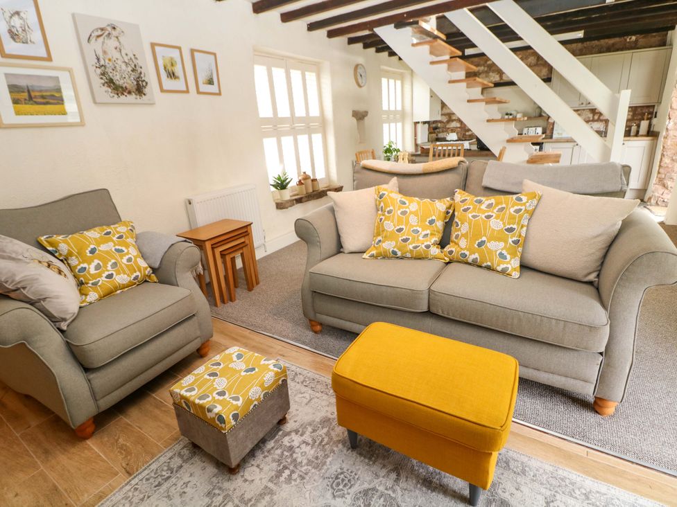 A living room with a sofa and footstool at Meadow View Cottage Whatstandwell near Crich