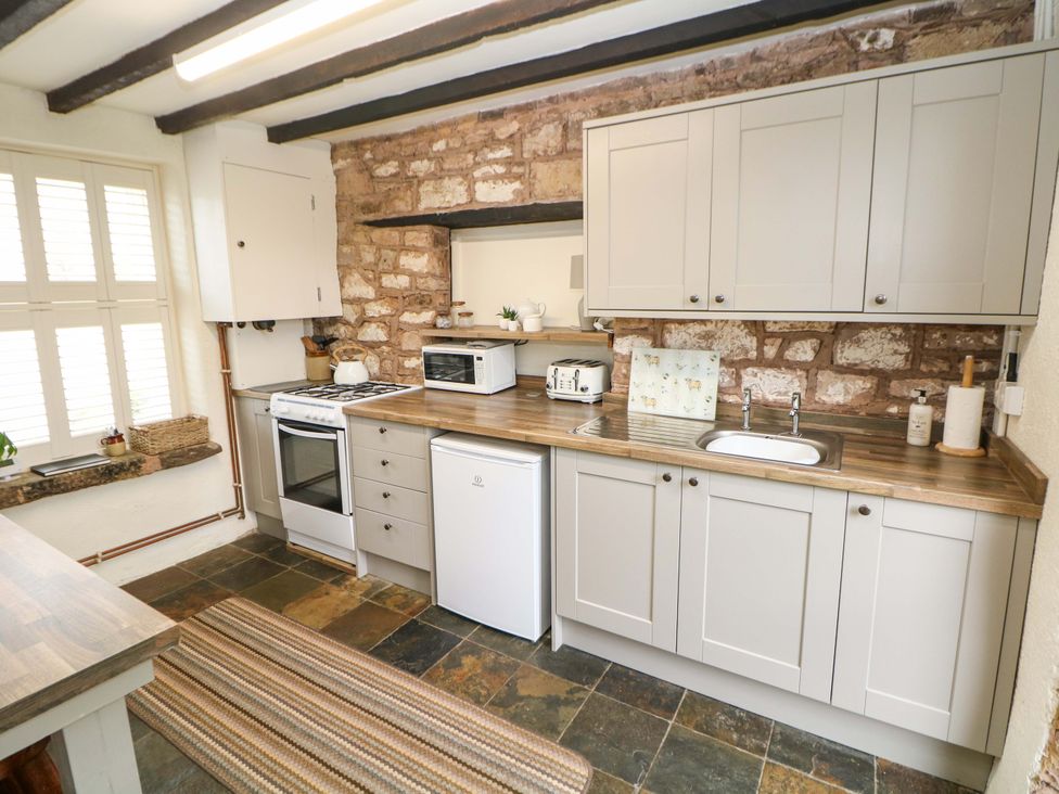 A kitchen with cabinets and appliances at Meadow View Cottage Whatstandwell near Crich