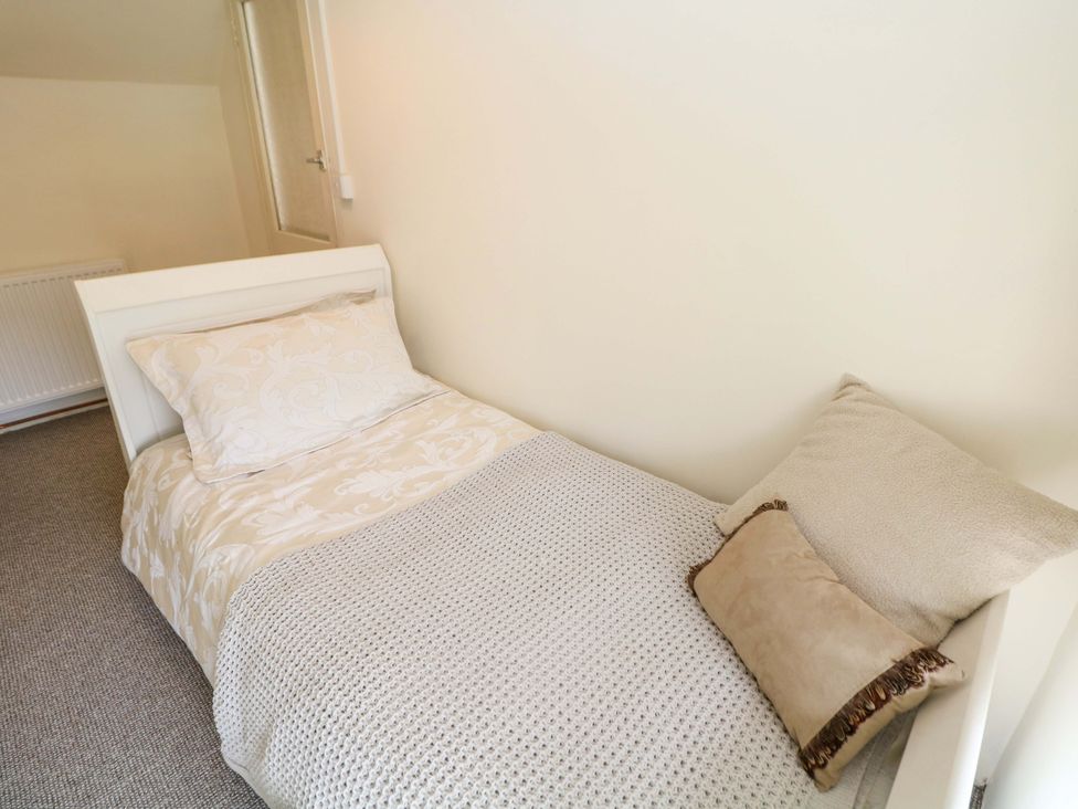 A bedroom with a bed and pillows at Meadow View Cottage in Whatstandwell near Crich