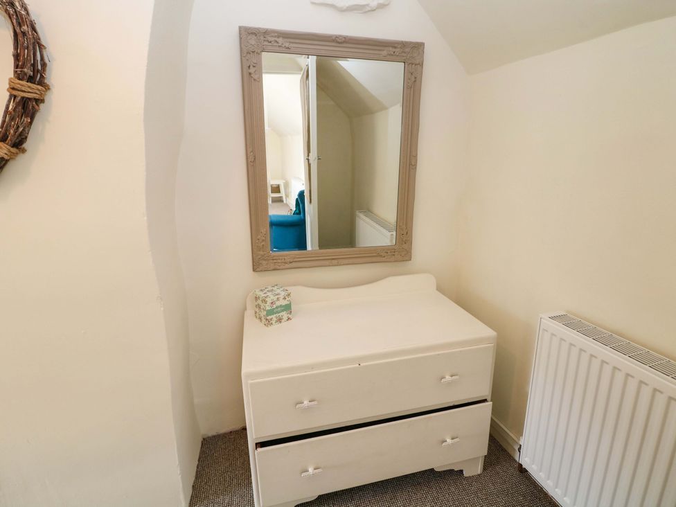 A bedroom featuring a dresser and mirror at Meadow View Cottage Whatstandwell near Crich