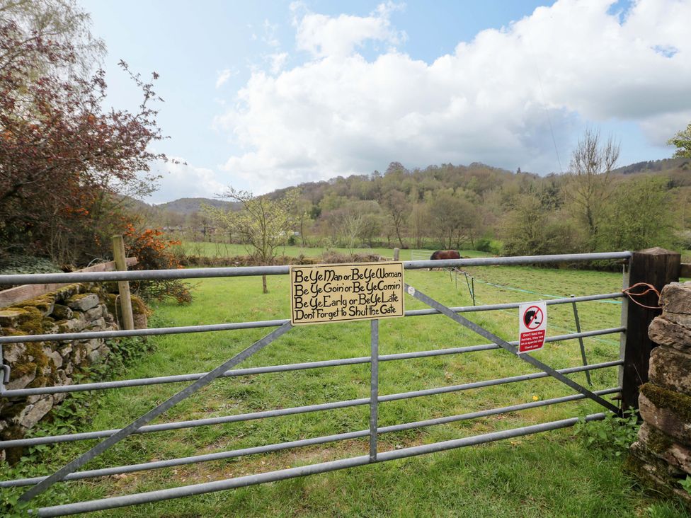 A gate with a sign in a field at Meadow View Cottage Whatstandwell near Crich