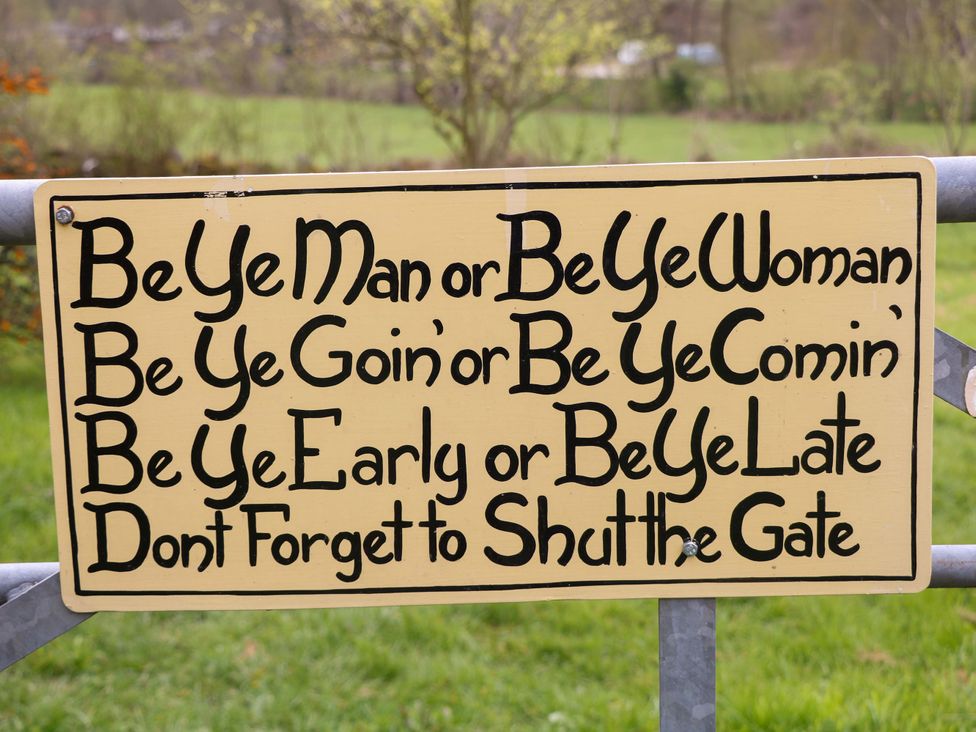A sign on a gate with a message at Meadow View Cottage Whatstandwell near Crich