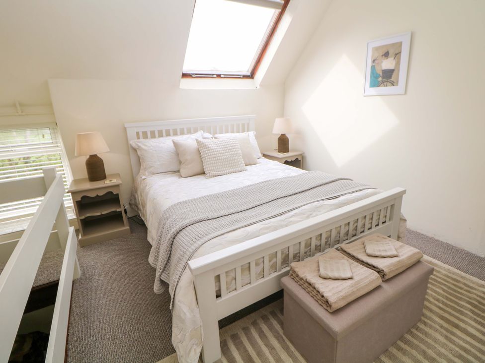 A bedroom with a bed and nightstands at Meadow View Cottage in Whatstandwell near Crich