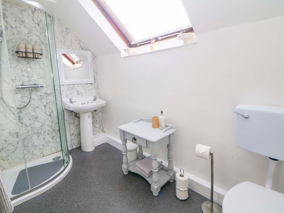 A bathroom with a shower, sink, and toilet at Meadow View Cottage Whatstandwell near Crich