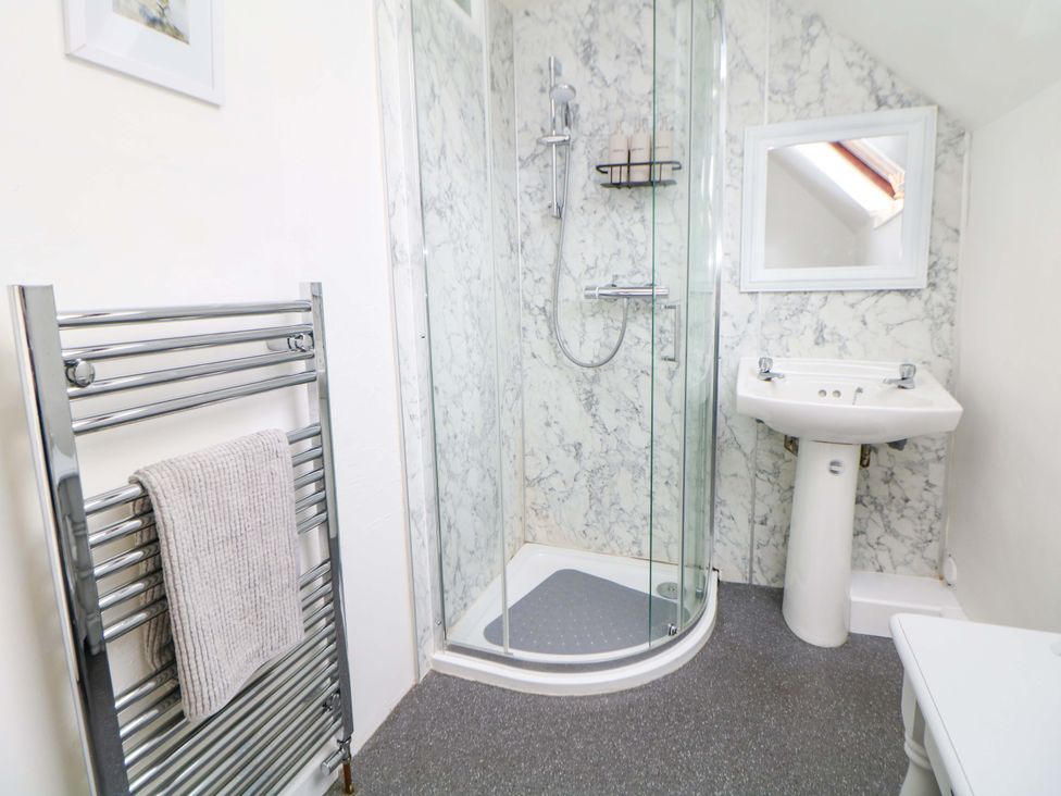 A bathroom with a shower, sink, and towel radiator at Meadow View Cottage Whatstandwell near Crich