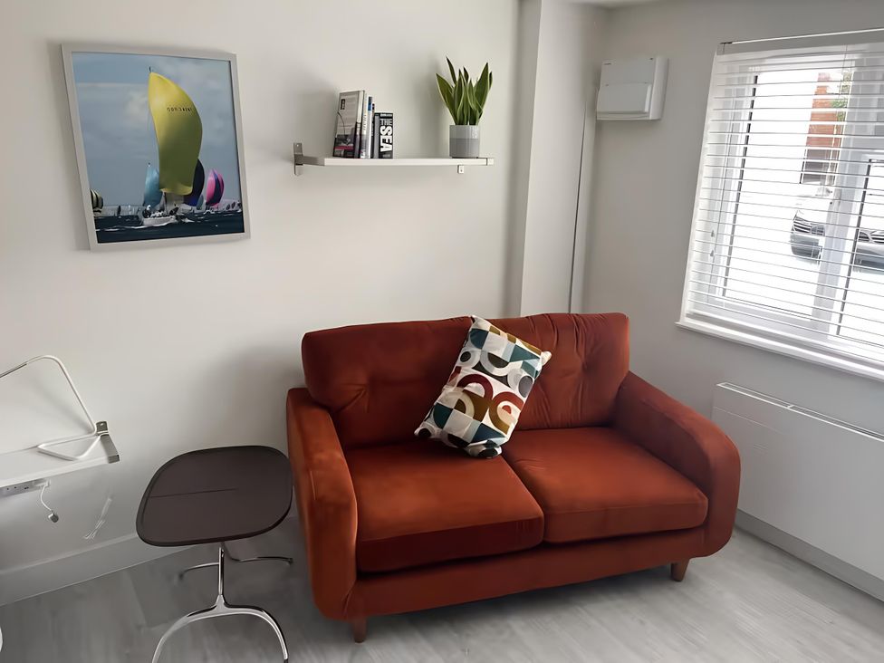 A living room with a sofa and table at River Studio in Warsash