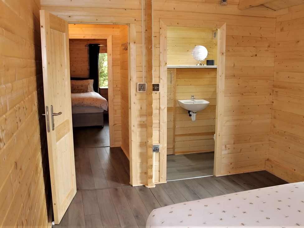 A bedroom with a bed and a mirror at Cotswold Nights Away 1 in Evesham