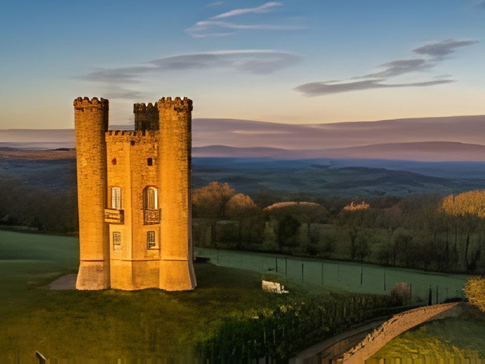 A tower in a landscape with fields and trees at Cotswold Nights Away 1 Evesham