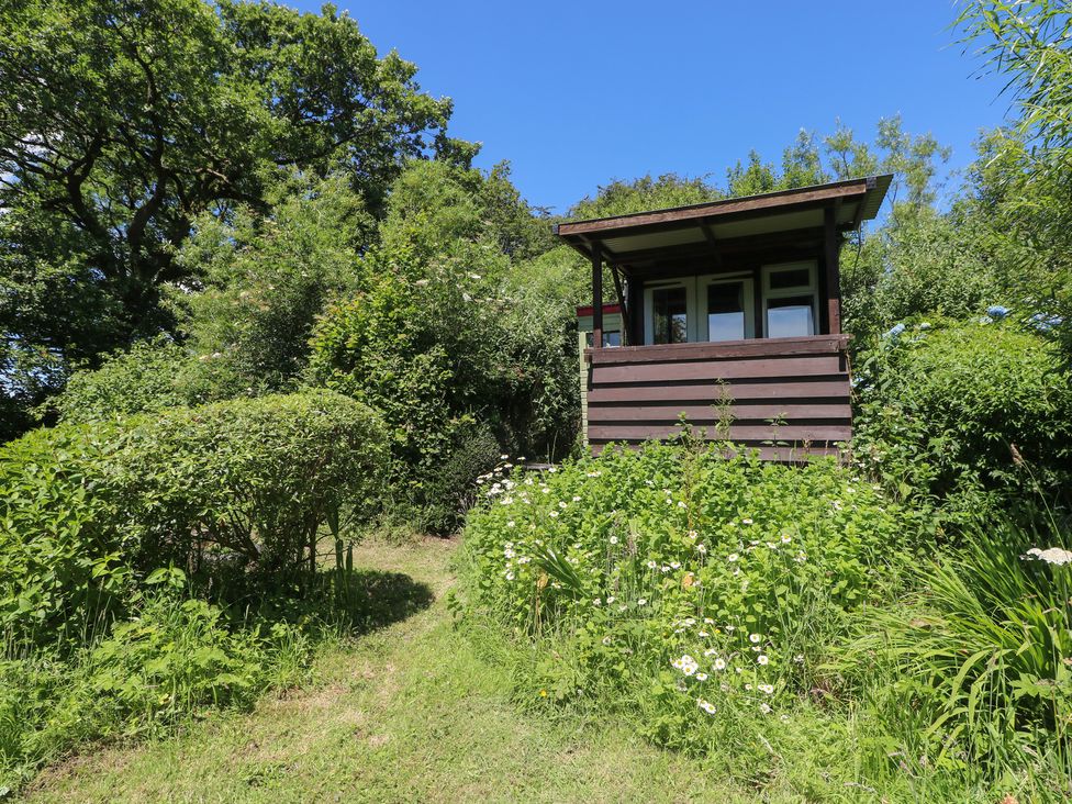 A house with a balcony surrounded by garden at Rumenco Horse Lorry