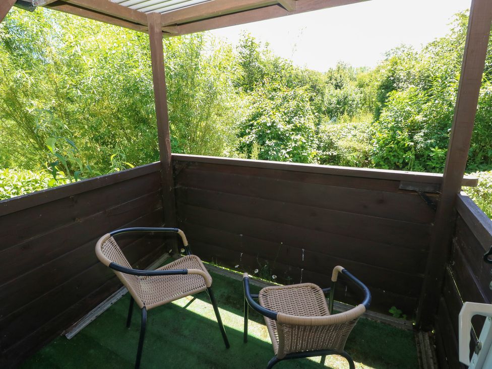 A balcony with two chairs and a view of greenery at Rumenco Horse Lorry