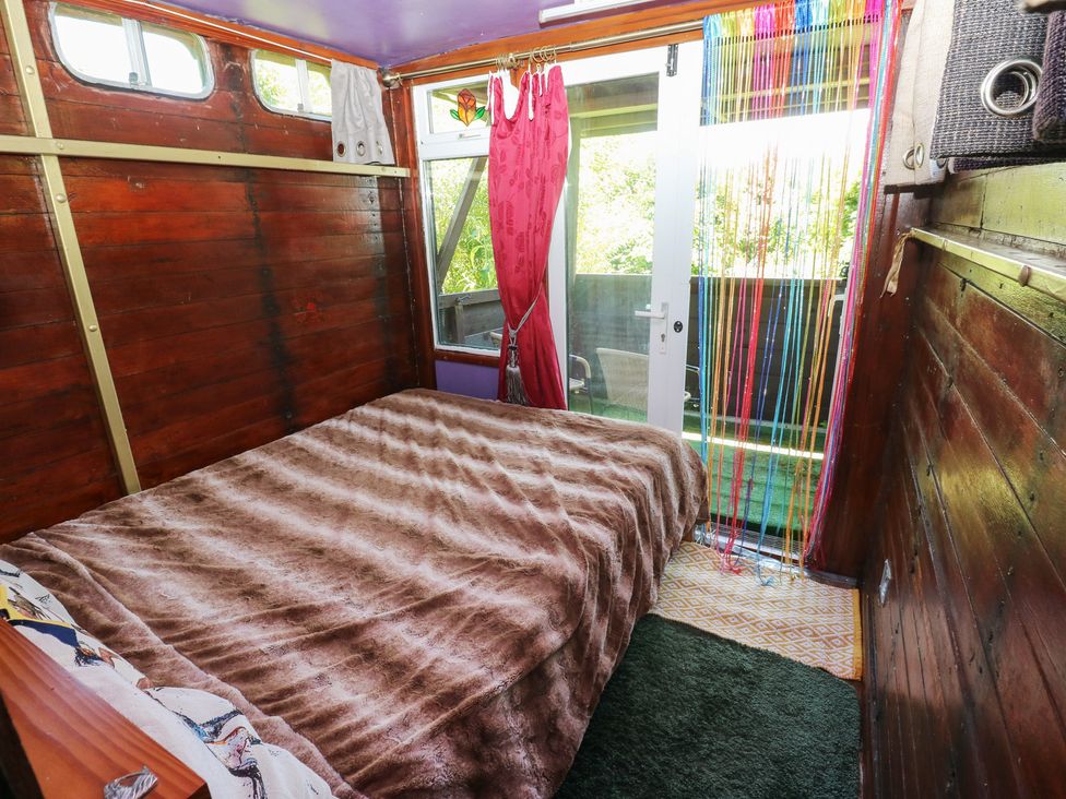 A bedroom with a bed and window at Rumenco Horse Lorry