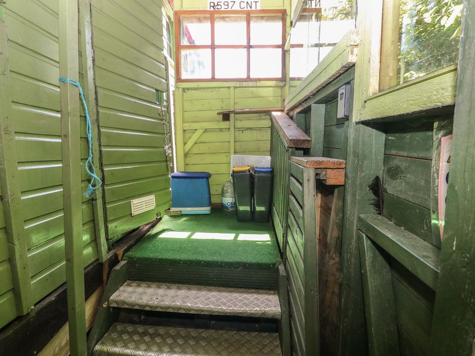 An outdoor area with stairs and bins at Rumenco Horse Lorry