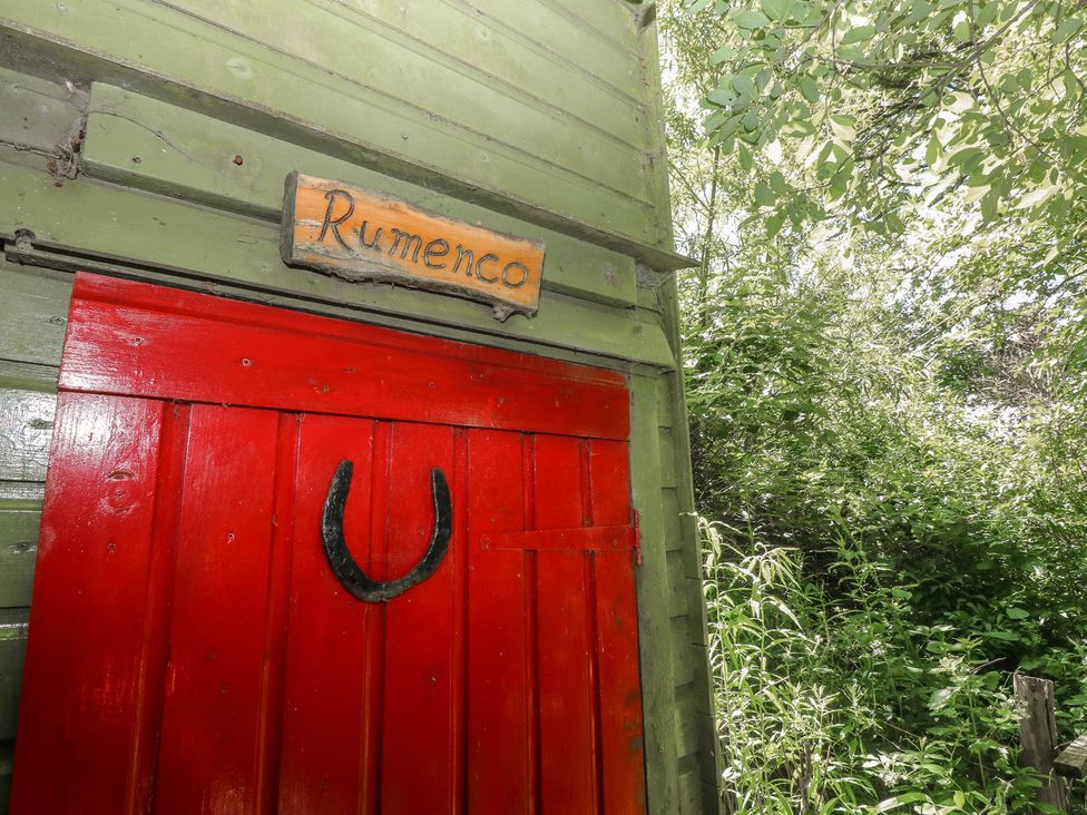 A door with a sign reading Rumenco and horseshoe attached at Rumenco Horse Lorry