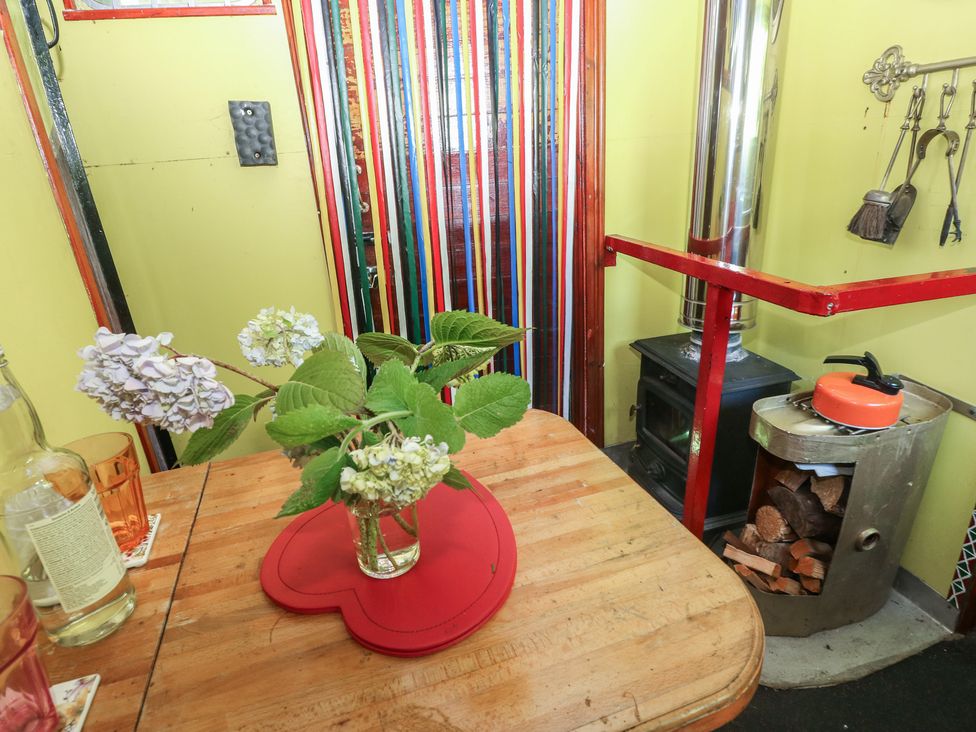 A kitchen with a vase of flowers on a table at Rumenco Horse Lorry