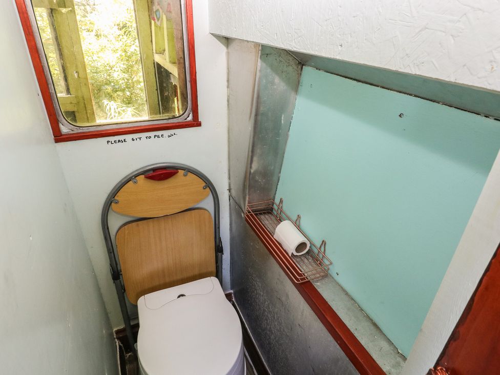 A bathroom with a toilet and window at Rumenco Horse Lorry 