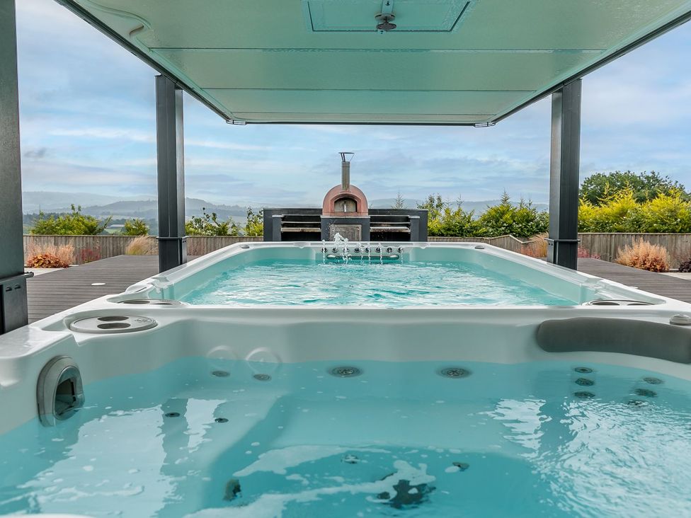 An outdoor space with a swimming pool and oven at Huxham View and Annex Stoke Canon