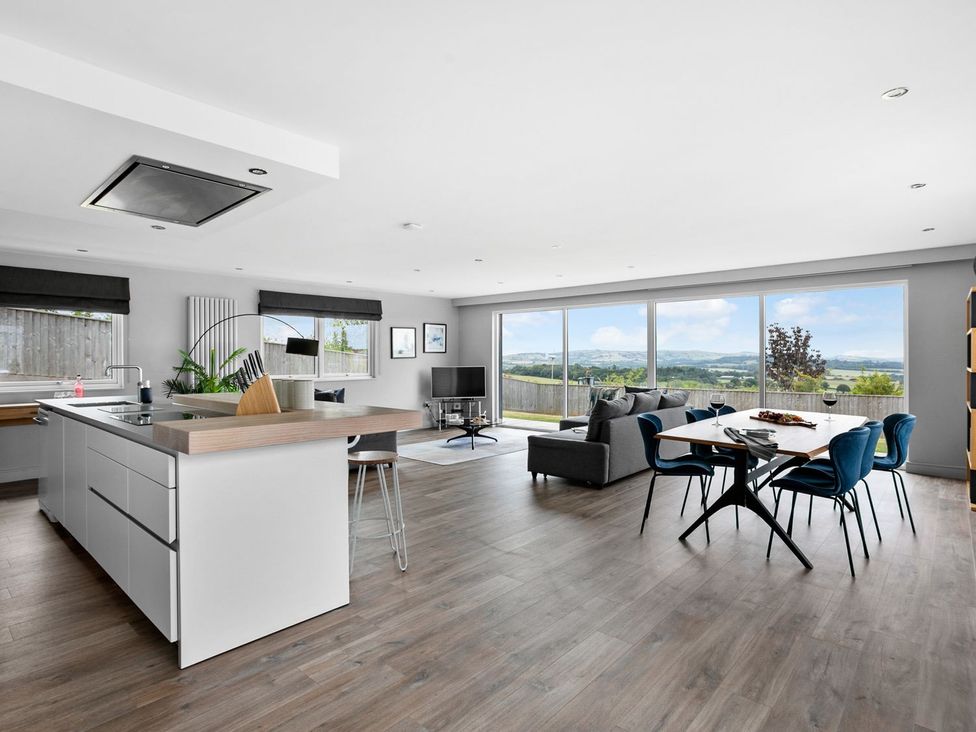 A living room with a kitchen island and dining area at Huxham View and Annex Stoke Canon