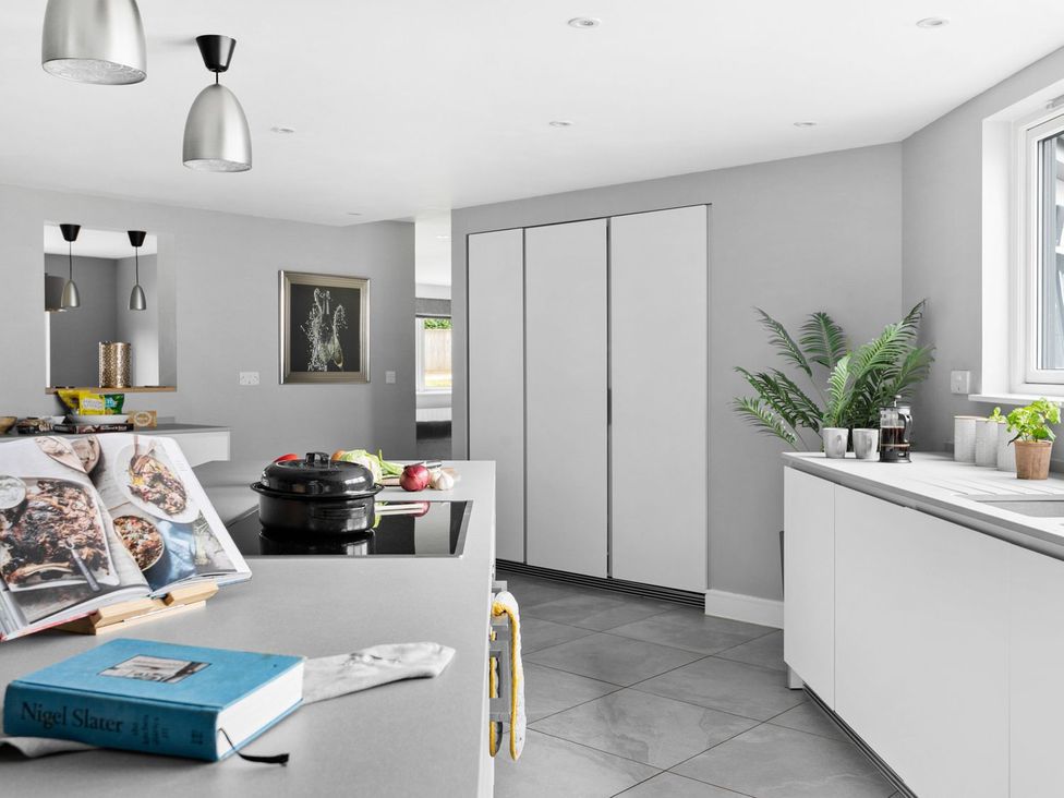 A kitchen with a central island and modern fixtures at Huxham View and Annex Stoke Canon