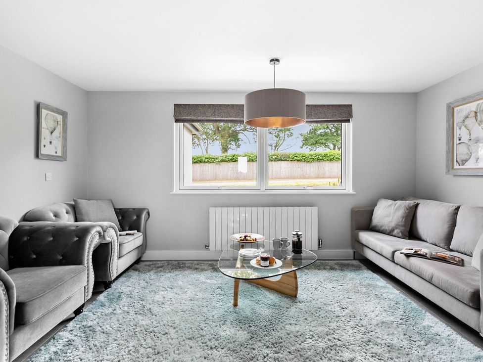 A living room with sofas and a coffee table at Huxham View and Annex Stoke Canon