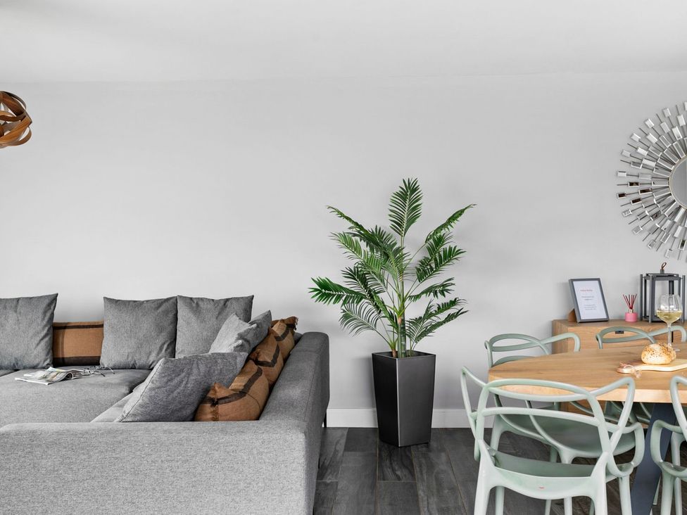 A living room with a sofa and dining area at Huxham View and Annex Stoke Canon