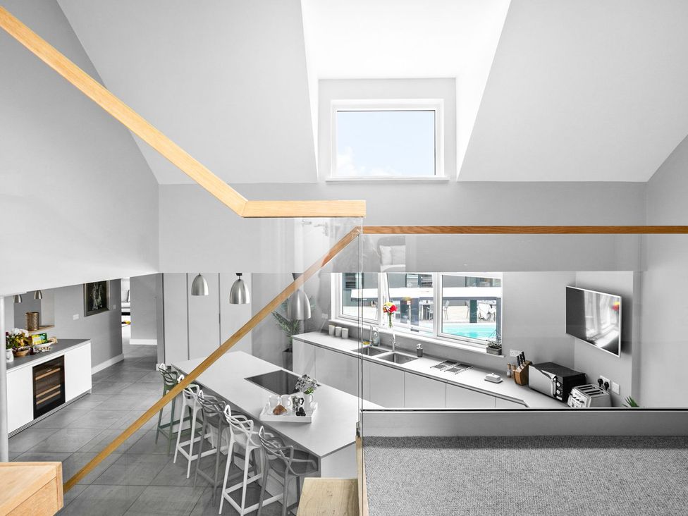 A kitchen with a window, island, and appliances at Huxham View and Annex Stoke Canon