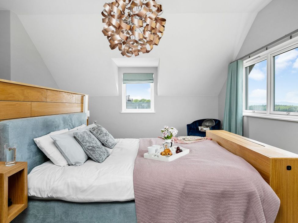 A bedroom with a bed and window at Huxham View and Annex Stoke Canon