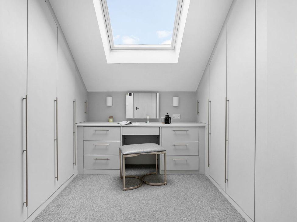 A dressing room featuring a desk and wardrobe at Huxham View and Annex, Stoke Canon