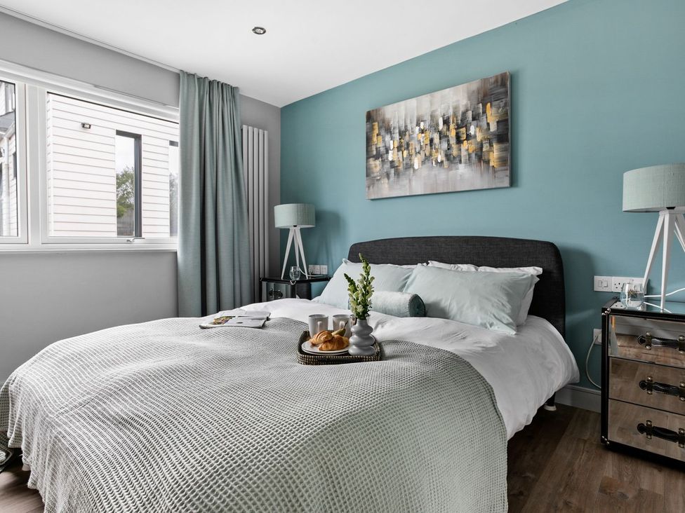 A bedroom with a bed and bedside table at Huxham View and Annex Stoke Canon