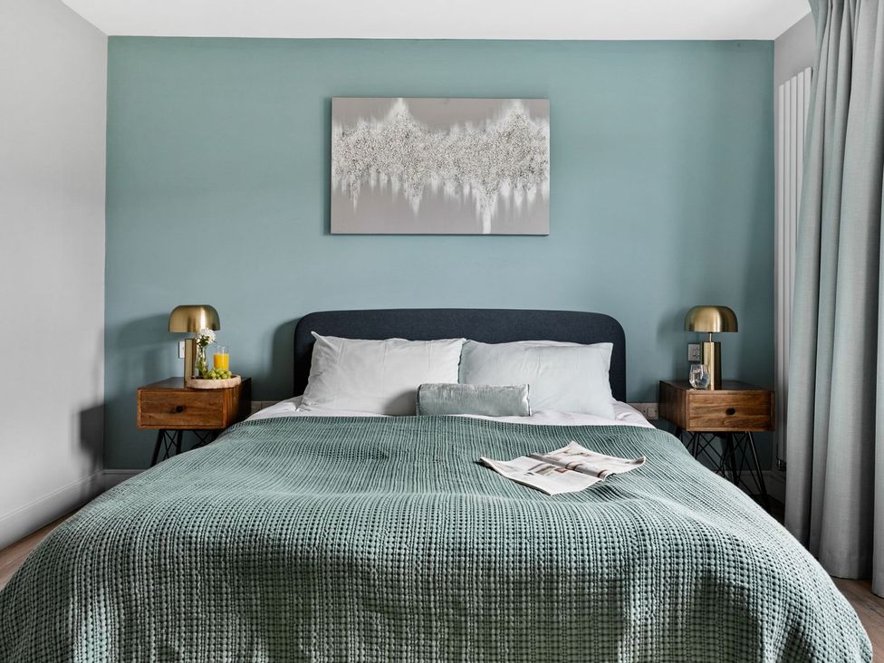 A bedroom with a bed and nightstands at Huxham View and Annex Stoke Canon