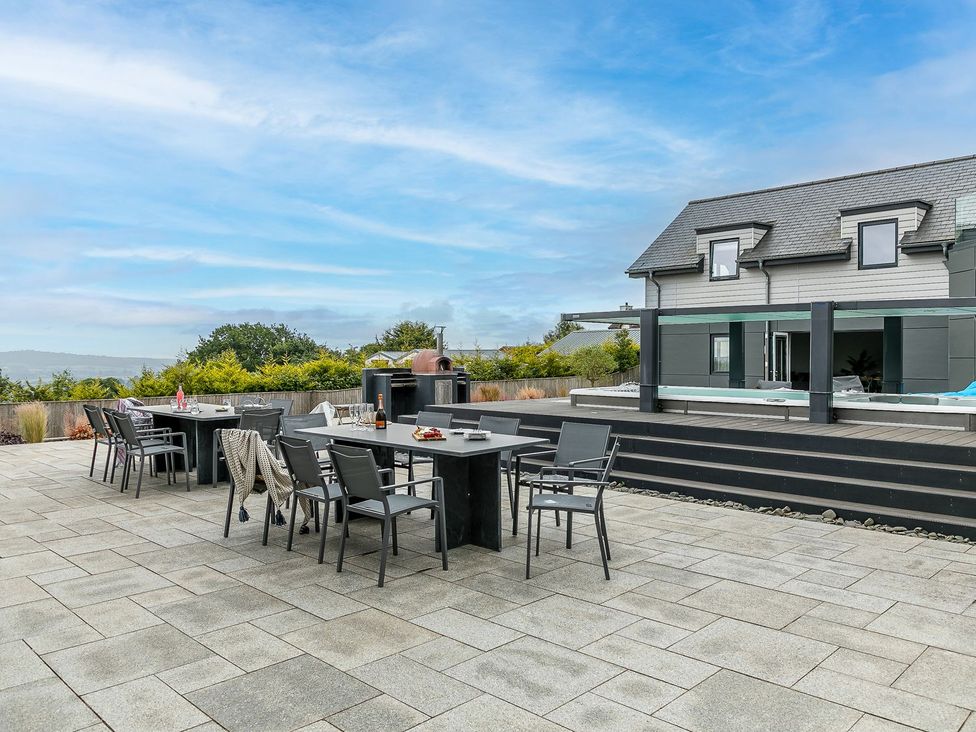 An outdoor dining area with tables and chairs at Huxham View and Annex Stoke Canon