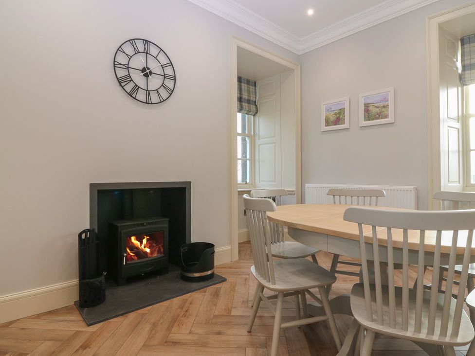 A dining room with a table and chairs at Balmashanner Farmhouse in Forfar