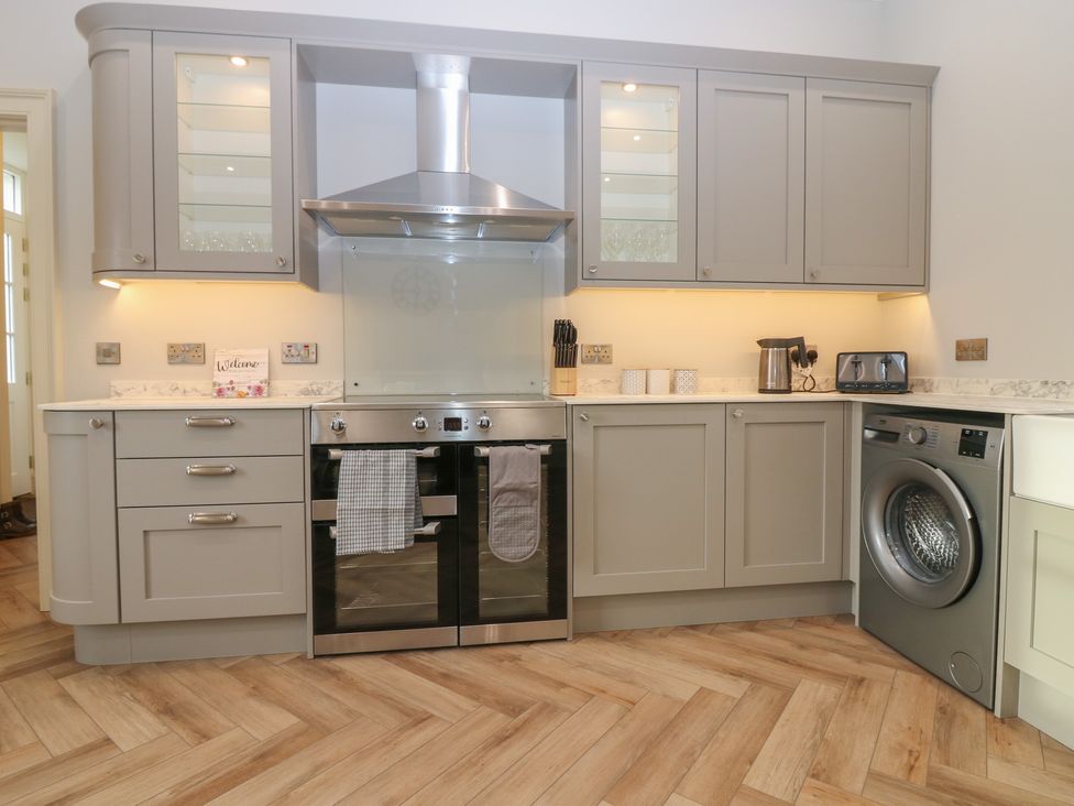 A kitchen with cabinets and appliances at Balmashanner Farmhouse in Forfar