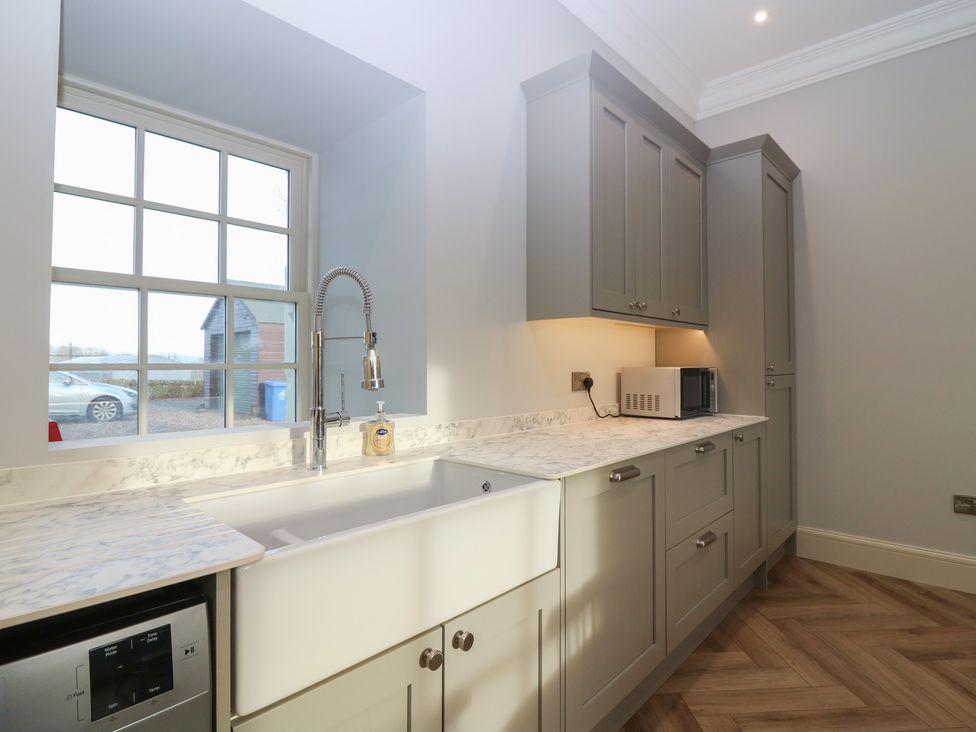 A kitchen with a sink and cabinets at Balmashanner Farmhouse Forfar