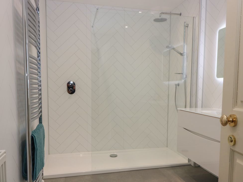 A bathroom with a shower and vanity unit at Balmashanner Farmhouse in Forfar